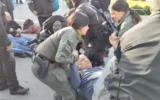 Police carry off protesters who blocked the entrance to the Knesset, January 8, 2024 (Twitter)